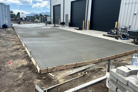 New Concrete apron for Peak Equipment Rentals in Monument, Colorado behind their bay doors
