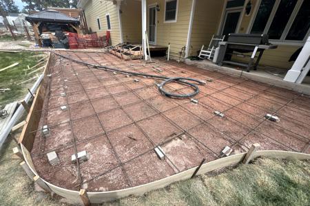 Concrete in Back Forest, Colorado had to be pumped to the back yard. The patio is formed up and you can see the amount of rebar we use along with the grading and compacting to assure concrete lasts a long time. Concrete does 3 things, gets hard, turns grey and cracks so we do our best to keep the cracking from happening