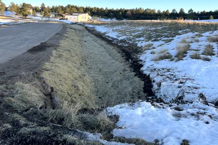 Winter time erosion control in Black Forest, Colorado for El Paso County DPW, installing erosion control blanket