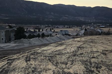 Erosion control in Monument, Colorado, seed and straw crimping the soil that was disturbed so that we can get grass to grow in these areas which will slow down the erosion.