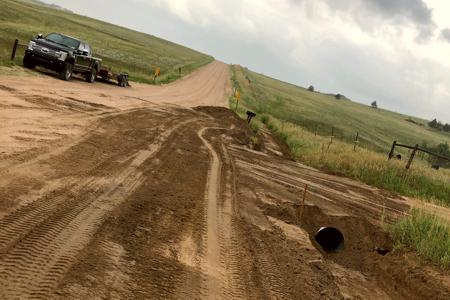 Culvert installed in Black Forest, Colorado so the homeowner was able to get into their property as the old one was plugged full and water was going over the driveway and washing it out.