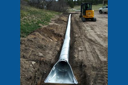 Culvert installation in Larkspur, Colorado for water to drain away from the barn and to control the erosion.