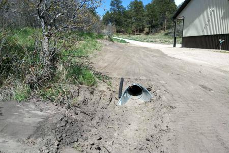 Culvert installation in Larkspur, Colorado for water to drain away from the barn and to control the erosion.