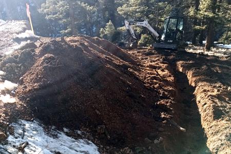 Excavating in Florissant, Colorado for the footer of our boulder retaining wall to enlarge the area leading into the garage