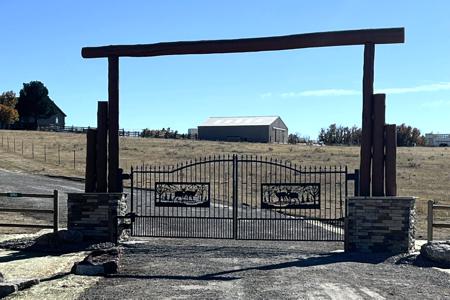Driveway gate in Larkspur, Colorado. Installed a solar powered driveway gate and entrance in Larkspur, Colorado. Graded the driveway and moved the fence accordingly.