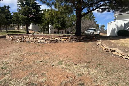 Siloam Stone retaining wall Monument, Colorado. Installed a Siloam Stone retaining wall around a tree to keep the mulch from sliding into the yard.